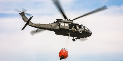 An Oklahoma Army National Guard UH-60 Black Hawk flies over the 702 Fire in Blaine County, Oklahoma after dropping more than 600 gallons of water on the fire, July 16, 2022. The Oklahoma National Guard is supporting the Oklahoma Forestry Services and local fire departments from the air using a UH-60 Black Hawk and a LUH-72 Lakota. (Oklahoma National Guard photo by Sgt. Anthony Jones)