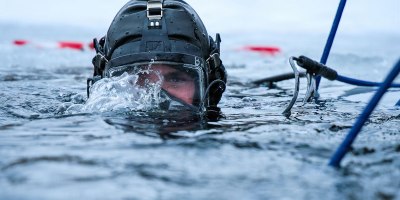 Equipment Operator 1st Class Devon Maher, U.S. Navy Seabee Diver assigned to Underwater Construction Team (UCT) One, Construction Dive Detachment Bravo (CDD/B), conduct ice diving operations during a bilateral ice diving exchange with Estonian Rescue Board and Estonian Navy divers at Rummu Quarry Lake, Feb. 10, 2026. The annual exercise enhances cold-weather diving proficiency and maritime readiness in the Baltic Sea region. UCT 1, CDD/B, currently deployed under 22nd Naval Construction Regiment (22 NCR), is a specially trained and equipped unit within Navy Expeditionary Combat Forces that specializes in diving, light salvage, underwater construction, and military engineering operations in austere environments.