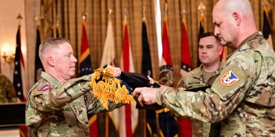 Lt. Gen. Michael McCurry, commanding general, Futures and Concepts Command, and Command Sergeant Major William Justice, command sergeant major, Futures and Concepts Command, unfurl the colors at the Futures and Concepts Command activation ceremony. (U.S. Army Photo by Jean Wines.)