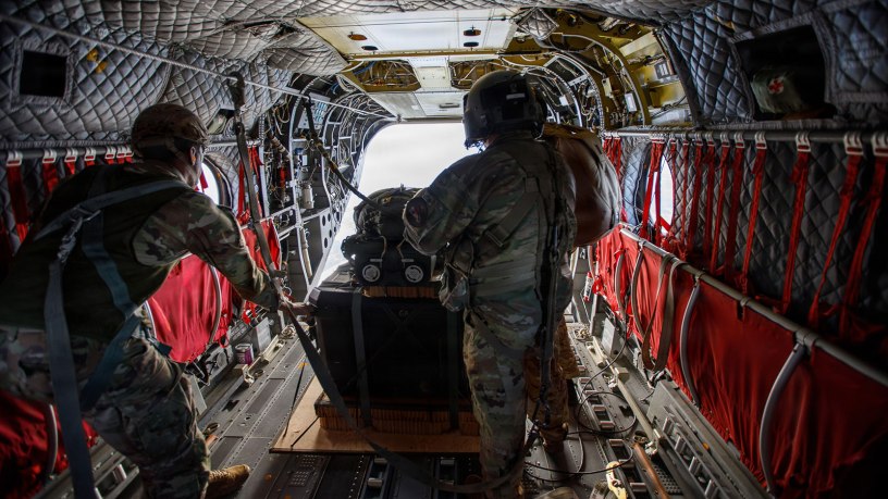 U.S. Soldiers assigned to 1st Special Forces Group (Airborne) load the Joint Precision Airdrop System at Joint Base Lewis-McChord, Washington, Feb. 12, 2026. JPADS is a self-steering, GPS and vision-guided airdrop platform consisting of a canopy and an autonomous guidance unit capable of landing within 100 meters of its target.