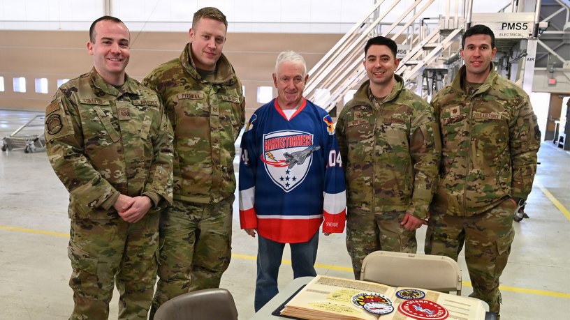 From Right to left U..S. Air Force Technical Sgt. Jason Gillette, 104th Fighter Wing Communications Squadron, Technical Sgt. Brett Pitoniak, 104th Fighter Wing Maintenance Squadron, retired Chief MSgt. John DeVecchi, 104th Fighter Wing, Master Sgt. Shane Morin, 104th Fighter Wing Maintenance Squadron, and Major Scott "Boom" McGowen Stand for a photo, 104th Fighter Wing Air National Guard base, Westfield, MA, February 13, 2026. DeVecchi started the original 104th Fighter Wing Hockey team in 1976 when they were part of the Pioneer Valley League Over 25 team and were called the Minutemen. (U.S. Air National Guard Photo by Melanie J. Casineau)