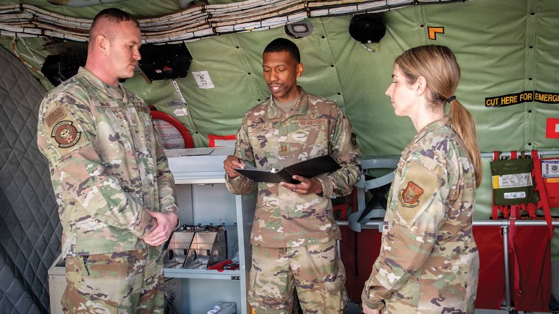 Capt. Darian Cornelius, 434th Air Refueling Wing chaplain, officiates the wedding of Master Sgt. Bryon Snead and Staff Sgt. Lynsey Chlebana, both 434th Aircraft Maintenance Squadron crew chiefs, aboard a KC-135R Stratotanker at Grissom Air Reserve Base, Ind., Feb. 17, 2026. Grissom is the largest KC-135 unit in Air Force Reserve Command with 16 tankers. (U.S. Air Force photo by Benjamin Mota)
