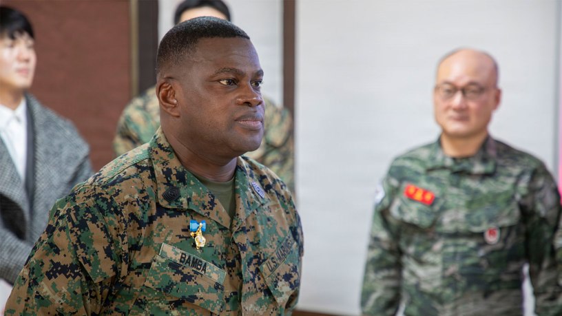 U.S. Marine Corps Sgt. Maj. Ismael G. Bamba, command senior enlisted leader of Marine Forces Korea, stands at attention as his citation is read during his award ceremony at Republic of Korea Marine Corps Headquarters at Camp Baran, South Korea, Feb. 3, 2026. The commendation highlights significant efforts supporting regional stability, alliance readiness and combined operational effectiveness on the Korean Peninsula. (U.S. Marine Corps photo by Gunnery Sgt. Antonio Campbell)