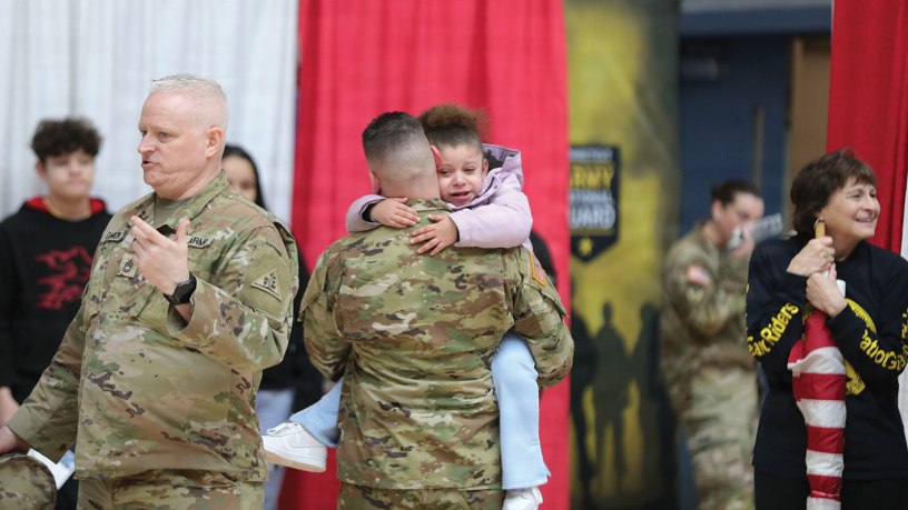 A soldier assigned to the Connecticut National Guard's 143rd Regional Support Group hugs his child following a sendoff ceremony for the unit at the Gov. William A. O'Neill Armory in Hartford, Conn. Feb. 21, 2026. The 143rd is scheduled to deploy to the Middle East in support of Operation Inherent Resolve. (U.S. Army photo by Spc. Juan Perez)