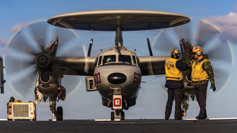 U.S. Navy Sailors signal to an E-2D Hawkeye aircraft, attached to Airborne Command and Control Squadron 124, as it taxis on the flight deck of world's largest aircraft carrier, USS Gerald R. Ford (CVN 78), in support of Operation Epic Fury, Feb. 28, 2026. (U.S. Navy photo)