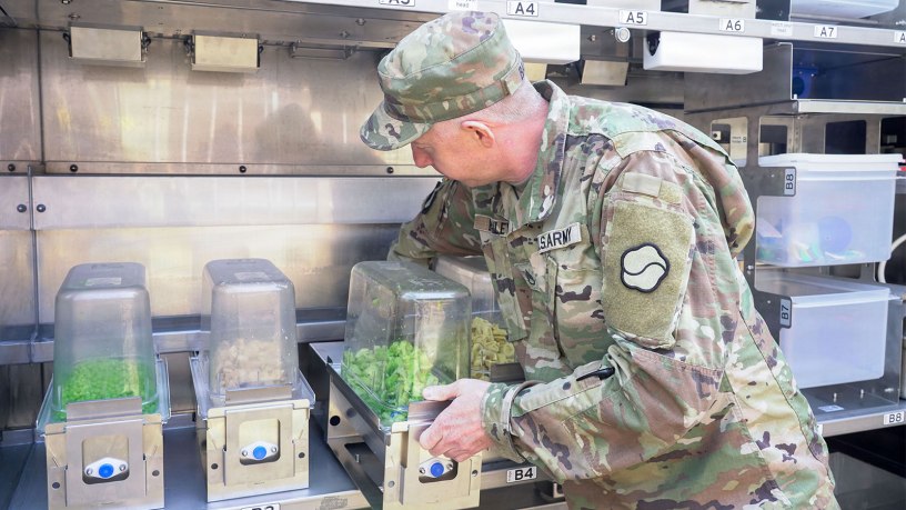 U.S. Army Staff Sgt. Darren Bailey, noncommissioned officer in charge of Market 19, 19th Expeditionary Sustainment Command, loads ingredients into the Sustained Autonomous Meals system at Camp Walker, Daegu, Republic of Korea, Mar. 26, 2026. The system allows a small team to support large formations by streamlining food preparation and increasing output through automation. (U.S. Army photo by Sgt. Deziree Keay)
