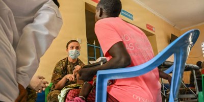 U.S. Army Capt. Bridget Keefe, a medical surgical nurse assigned to the Massachusetts Army National Guard Medical Detachment, consults a local patient with a local civilian medical team member during the Justified Accord 2026 Medical Civic Action Program at Archers Post Sub-County Hospital, Samburu County, Kenya, Feb. 26, 2026.