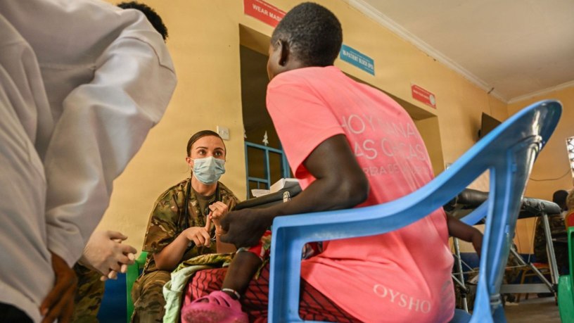 U.S. Army Capt. Bridget Keefe, a medical surgical nurse assigned to the Massachusetts Army National Guard Medical Detachment, consults a local patient with a local civilian medical team member during the Justified Accord 2026 Medical Civic Action Program at Archers Post Sub-County Hospital, Samburu County, Kenya, Feb. 26, 2026.