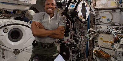 NASA astronaut and U.S. Navy Capt. Victor Glover, shown aboard the International Space Station with an Astrobee, is one of many NPS alumni, students and faculty members who have contributed to the U.S. space program – and helped expand the boundaries of space education and research. (Courtesy photo by NASA)