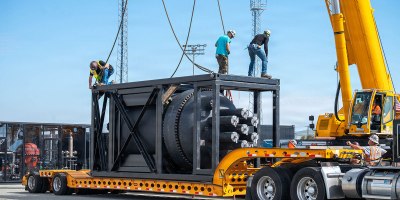 A containerized nuclear power reactor sits secured within a reinforced steel transport frame at March Air Reserve Base, California, Feb. 13, 2026. The system is part of an interagency demonstration evaluating the feasibility of rapidly deploying nuclear power using strategic airlift. (U.S. Air Force photo by SSgt Monique Bright)