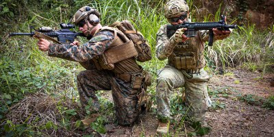 U.S. Marine Corps Lance Cpl. Peter D. Deluke, left, a combat engineer with 2nd Combat Engineer Battalion, 2nd Marine Division, kneels alongside Cabo Segundo Abdiel Zuñiga, a member of the Infantería de Marina, Servicio Nacional Aeronaval de Panamá, for a photo after the conclusion of a live-fire fire team attack range at Camp Cerro Tigre, Panama, Feb. 19, 2026. The training, conducted as part of Panamanian Partnership 26, enhanced interoperability and shared capabilities by enabling U.S. Marines with 2nd CEB to train alongside Panamanian security institutions in a combined training environment. (U.S. Marine Corps photo by Sgt. Antonino Mazzamuto)