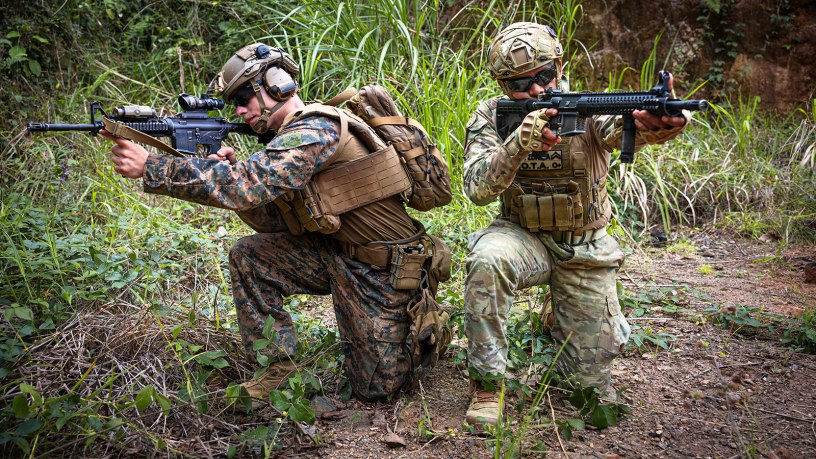 U.S. Marine Corps Lance Cpl. Peter D. Deluke, left, a combat engineer with 2nd Combat Engineer Battalion, 2nd Marine Division, kneels alongside Cabo Segundo Abdiel Zuñiga, a member of the Infantería de Marina, Servicio Nacional Aeronaval de Panamá, for a photo after the conclusion of a live-fire fire team attack range at Camp Cerro Tigre, Panama, Feb. 19, 2026. The training, conducted as part of Panamanian Partnership 26, enhanced interoperability and shared capabilities by enabling U.S. Marines with 2nd CEB to train alongside Panamanian security institutions in a combined training environment. (U.S. Marine Corps photo by Sgt. Antonino Mazzamuto)