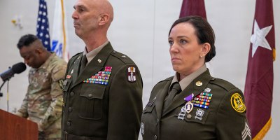 Brig. Gen. Todd Traver, deputy commanding general of the 807th Theater Medical Command, presents the Purple Heart to retired U.S. Army Reserve Sgt. 1st Class Christina Larson during her retirement ceremony at Fort Sheridan, Illinois, Feb. 20, 2026. Larson received the award for wounds sustained during a 2015 deployment to Afghanistan. (U.S. Army Reserve photo by Staff Sgt. Mikayla Fritz)