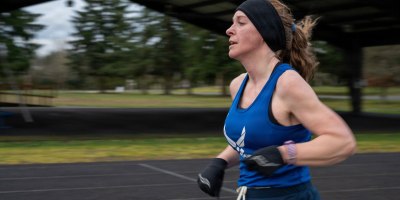 Air Force Senior Master Sgt. Tiffany Hallmark, 446th Force Support Squadron chief of cyber operations, runs on the track at Joint Base Lewis-McChord, Wash., Feb. 27, 2026.