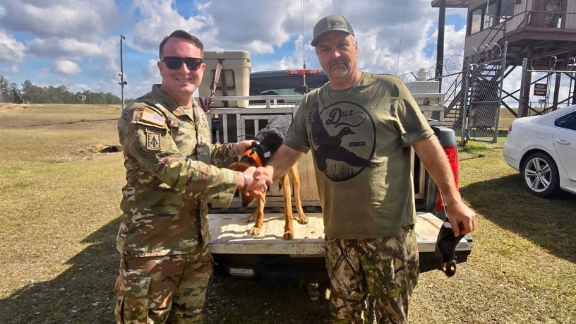 1st Sgt. Jonathan Merck, with the U.S. Army 310th Psychological Operations Company, U.S. Army Reserve, poses with Mr. Welborn and his hunting dog that he rescued during exercise Sentry South 26-2, at Camp Shelby Joint Forces Training Center, Mississippi, Feb. 28, 2026.