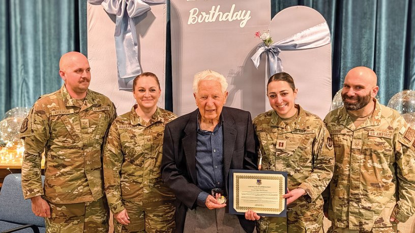 Left to right, Senior Airman Jason Anderson, 67th Aerial Port Squadron air transportation journeyman, Master Sgt. Jennifer Ramaekers, 151st Utah Air Nation Guard munitions, William Reid Rowland, Captain Leila Rahebi Air Force contracting officer, and Tech. Sgt. Dom Gioffre, 67th Aerial Port Squadron air transportation craftsman, pose for a picture for Rowland’s 100th birthday on Feb. 28, 2026. (Courtesy Photo)