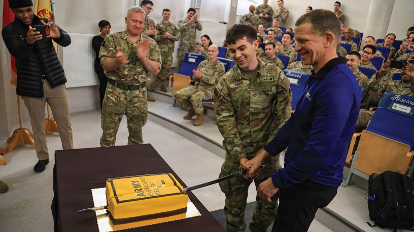 Army Emergency Relief CEO, retired Sergeant Major of the Army Tony Grinston, cuts the cake to celebrate the opening of the AER branch at the U.S. Army Garrison Poland on March 3, 2026, in Poznan, Poland. The opening of the branch includes a pilot program for U.S. Army Reserve Soldiers to receive access to loan and grants. (U.S. Army Reserve photo by Staff Sgt. Stanford Toran)