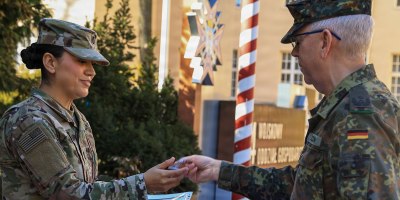 U.S. Army Reserve 1st Lt. Vanessa Medina, executive officer with the 510th Regional Support Group, 7th Mission Support Command, receives her certificate of completion and medal from Lt. Col. Ulrich Hoecken, German senior national representative to V Corps, during the award ceremony on March 3, 2026, in Poznan, Poland. This was the first time Medina has participated in the German Armed Forces Proficiency Badge competition. (U.S. Army Reserve photo by Staff Sgt. Stanford Toran)