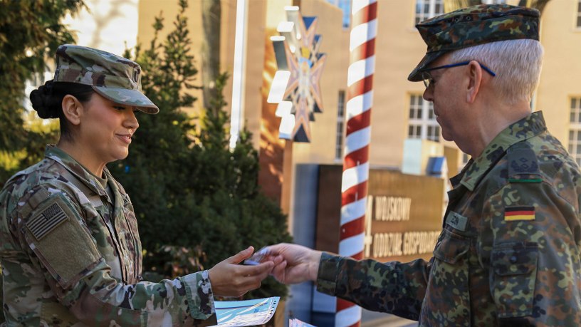 U.S. Army Reserve 1st Lt. Vanessa Medina, executive officer with the 510th Regional Support Group, 7th Mission Support Command, receives her certificate of completion and medal from Lt. Col. Ulrich Hoecken, German senior national representative to V Corps, during the award ceremony on March 3, 2026, in Poznan, Poland. This was the first time Medina has participated in the German Armed Forces Proficiency Badge competition. (U.S. Army Reserve photo by Staff Sgt. Stanford Toran)