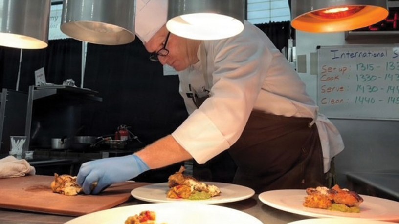 Chief Warrant Officer 4 Colby Beard, 807th Theater Medical Command, plates a dish during the live cooking portion of the Joint Culinary Training Exercise at Fort Gregg-Adams, Virginia, Feb. 27–March 4, 2026. Beard competed in the international challenge, preparing a poultry-based entrée under timed conditions against international military teams.
