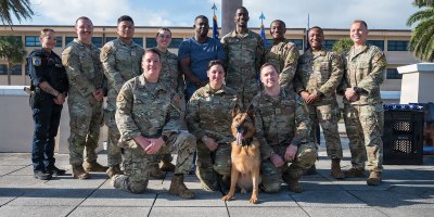 Members of the 45th Security Squadron pose for a photo at Patrick Space Force Base, Florida, March 6, 2026. Military Working Dog, Ory, served as a dual-purpose military working dog supporting patrol and explosive detection missions, including Secret Service support details and a 2025 deployment to Al Dhafra Air Base, United Arab Emirates. (U.S. Space Force photo by Gwendolyn Kurzen)