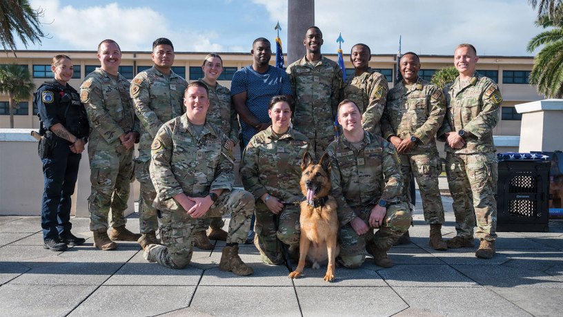 Members of the 45th Security Squadron pose for a photo at Patrick Space Force Base, Florida, March 6, 2026. Military Working Dog, Ory, served as a dual-purpose military working dog supporting patrol and explosive detection missions, including Secret Service support details and a 2025 deployment to Al Dhafra Air Base, United Arab Emirates. (U.S. Space Force photo by Gwendolyn Kurzen)