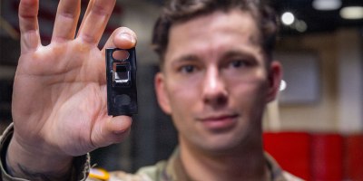 Sgt. Aidan Hanson, a paratrooper assigned to Headquarters and Headquarters Battery, Division Artillery, 82nd Airborne Division, holds up a 3-D printed washing machine part in the Airborne Innovation Lab, on Fort Bragg North Carolina, March 9, 2026. Hanson’s innovation hopes to save the XVIII Airborne Corps thousands of dollars and have unserviceable washers fixed faster. (U.S. Army Photo by Sgt. Prim Hibbard)