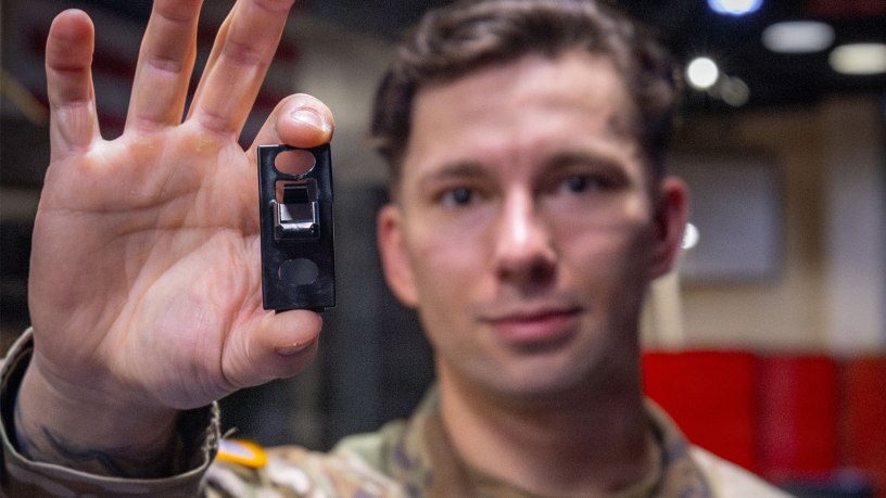 Sgt. Aidan Hanson, a paratrooper assigned to Headquarters and Headquarters Battery, Division Artillery, 82nd Airborne Division, holds up a 3-D printed washing machine part in the Airborne Innovation Lab, on Fort Bragg North Carolina, March 9, 2026. Hanson’s innovation hopes to save the XVIII Airborne Corps thousands of dollars and have unserviceable washers fixed faster. (U.S. Army Photo by Sgt. Prim Hibbard)