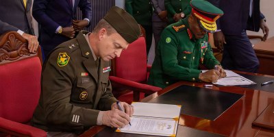 U.S. Army Maj. Gen. Craig Strong, left, Nebraska’s adjutant general, and Gen. Jacob John Mkunda, chief of defense forces for the Tanzania Peoples’ Defence Forces, sign a formal letter of intent in Dar es Salaam, Tanzania, March 12, 2026. The agreement officially links the Nebraska National Guard and Tanzania through the National Guard Bureau’s State Partnership Program. Photo by Staff Sgt. Gauret Stearns.