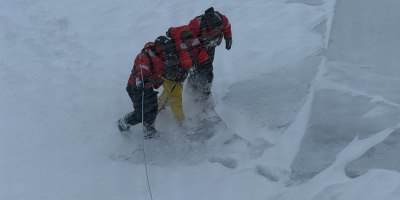 U.S. Coast Guard ice rescue team members, assigned to Coast Guard Cutter Mackinaw (WLBB 30), assist an individual to safety aboard the cutter during a rescue near Mackinac island, Michigan, March 15, 2026. The Mackinaw maneuvered to the ice edge, deployed the ice rescue team to safely recover the individual, and provided him medical care once aboard the vessel. (U.S. Coast Guard photo by Lt. William Erekson)