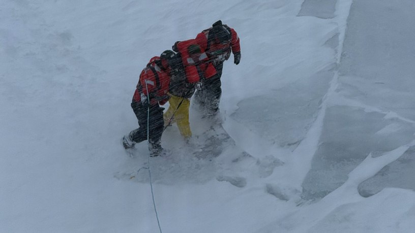 U.S. Coast Guard ice rescue team members, assigned to Coast Guard Cutter Mackinaw (WLBB 30), assist an individual to safety aboard the cutter during a rescue near Mackinac island, Michigan, March 15, 2026. The Mackinaw maneuvered to the ice edge, deployed the ice rescue team to safely recover the individual, and provided him medical care once aboard the vessel. (U.S. Coast Guard photo by Lt. William Erekson)