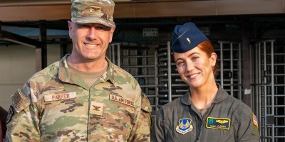 U.S. Air Force Col. William Parker, United States Forces Korea J1 assistant chief of staff, and 2nd Lt. Avery Parker, 607 Air Operations Center combat operations division flight test engineer augmentee, pose for a photo at Osan Air Base, Republic of Korea, March 17, 2026. The Parker family’s connection to Korea spans three generations, including William Parker’s father who flew missions along the Demilitarized Zone as a reconnaissance navigator during the Cold War Era. (U.S. Air Force photo by Staff Sgt. Evan Porter)