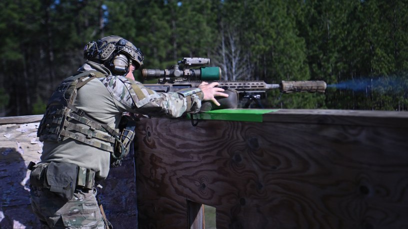 A competitor in the 17th Annual United States Army Special Operations Command International Sniper Competition shoots a rifle at multiple long-distance targets on a range at Fort Bragg, North Carolina, March 18, 2026.
