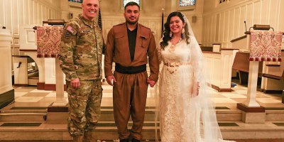 U.S. Army Brig. Gen. Leland D. Blanchard II, Commanding General (interim) of the District of Columbia National Guard, Hasan Alpkan and Spc. Ester Henriquez, an Indiana National Guard member assigned to Joint Task Force - DC, pose for a photo after their wedding ceremony at the Old Post Chapel on Fort Myer, Virginia, March 21, 2026. About 2,700 National Guard members support the D.C. Safe and Beautiful mission, assisting the Metropolitan Police Department in maintaining public safety for residents, commuters and visitors throughout the District. (D.C. National Guard photo by Tech. Sgt. Melissa Sterling)