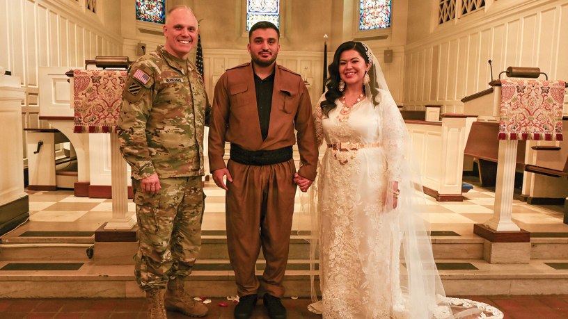 U.S. Army Brig. Gen. Leland D. Blanchard II, Commanding General (interim) of the District of Columbia National Guard, Hasan Alpkan and Spc. Ester Henriquez, an Indiana National Guard member assigned to Joint Task Force - DC, pose for a photo after their wedding ceremony at the Old Post Chapel on Fort Myer, Virginia, March 21, 2026. About 2,700 National Guard members support the D.C. Safe and Beautiful mission, assisting the Metropolitan Police Department in maintaining public safety for residents, commuters and visitors throughout the District. (D.C. National Guard photo by Tech. Sgt. Melissa Sterling)