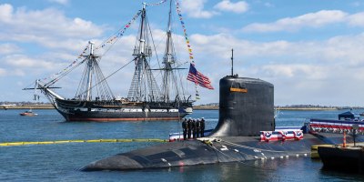 The USS Constitution sails past the Virginia-class nuclear-powered fast-attack submarine USS Massachusetts (SSN 798) during Massachusetts’ commissioning in Boston, on March 28th, 2026. Massachusetts is the newest fast-attack submarine and the fifth U.S. Navy vessel to bear the name. (U.S. Navy photo by Mass Communication Specialist 2nd Class Lucas J. Hastings)