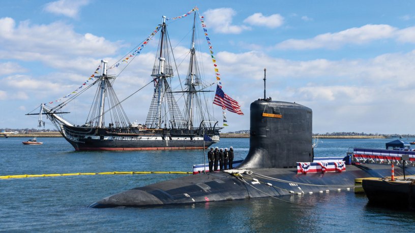 The USS Constitution sails past the Virginia-class nuclear-powered fast-attack submarine USS Massachusetts (SSN 798) during Massachusetts’ commissioning in Boston, on March 28th, 2026. Massachusetts is the newest fast-attack submarine and the fifth U.S. Navy vessel to bear the name. (U.S. Navy photo by Mass Communication Specialist 2nd Class Lucas J. Hastings)