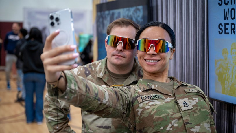 Soldiers take a selfie at a recruiting event.