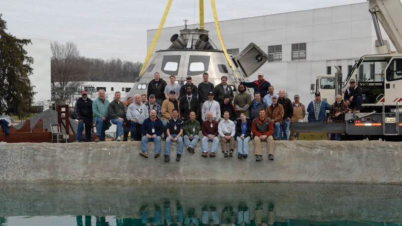 Engineers and technicians with the Naval Surface Warfare Center, Carderock Division, pose at the command’s test pond in West Bethesda, Maryland, March 25, 2009. The team supported the development and testing of NASA’s Orion capsule, conducting full-scale and model-scale evaluations of the capsule's performance during splashdown and recovery operations. Pictured are Mark Melendez, front row, second from left, and Lauren “Tink” Hanyok, front row, second from right. (U.S. Navy photo)