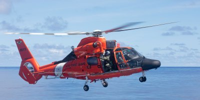 Petty Officer 2nd Class Lonnie Taber retrieves the winch on a U.S. Coast Guard MH-65E Dolphin helicopter following an in-flight refueling evolution with U.S. Coast Guard Cutter Munro (WMSL 755) in the Philippine Sea, Sept. 26. Munro is deployed to the Indo-Pacific to advance relationships with ally and partner nations to build a more stable, free, open and resilient region with unrestricted, lawful access to the maritime commons. (U.S. Navy photo by Chief Petty Officer Brett Cote)