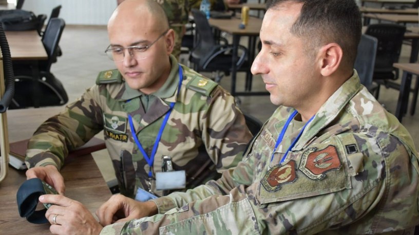 U.S. Air Force Master Sgt. Babak Kermanshahi (right), a communications theater operations planner assigned to Headquarters U.S. Air Forces in Europe – Air Forces Africa, and a member of the Royal Armed Forces of Morocco connect to a U.S. Link 16 network on using Moroccan computer equipment ahead of African Lion 2026 (AL26) at Agadir, Morocco, Feb. 3, 2026.