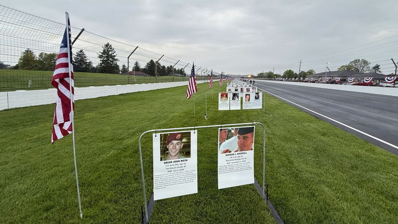 Placards of Indiana's fallen service members line the back straight at the Indianapolis Motor Speedway as part of the Gold Mile prior the 500 Festival Mini-Marathon in Indianapolis, Saturday, May 3, 2025. The Gold Mile honors Indiana's fallen service members since Sept 11, 2001. (Indiana National Guard photo by Master Sgt. Jeff Lowry)