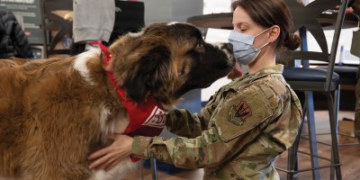 U.S. Air Force Senior Airman Kailah Khamjani, 633d Surgical Squadron radiology technician, interacts with Rocky Road, a registered therapy dog, at Joint Base Langley-Eustis, Virginia, Feb. 17, 2026. Rocky Road is a certified therapy dog who assists with stress-relief, comfort and morale improvement. (U.S. Air Force photo by Airman 1st Class Chloe Goodman)