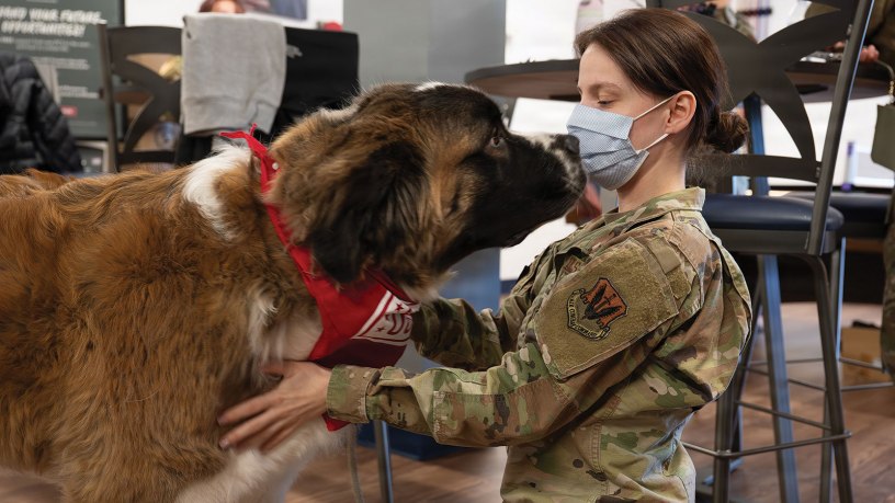 U.S. Air Force Senior Airman Kailah Khamjani, 633d Surgical Squadron radiology technician, interacts with Rocky Road, a registered therapy dog, at Joint Base Langley-Eustis, Virginia, Feb. 17, 2026. Rocky Road is a certified therapy dog who assists with stress-relief, comfort and morale improvement. (U.S. Air Force photo by Airman 1st Class Chloe Goodman)