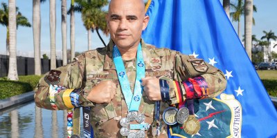 U.S. Air Force Col. Alfredo “Juny” Laboy poses with his World Marathon Majors medals outside U.S. Southern Command headquarters in Miami, Feb. 24, 2026. Laboy became the first active-duty service member to complete all seven World Marathon Majors within a single calendar year, marking a rare endurance achievement across the global race series. (Courtesy photo)