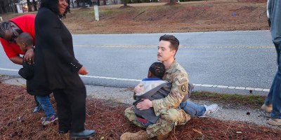 U.S. Army Capt. Jeremy Willman comforts a child after a vehicle accident in front of the armory in Wadesboro, N.C., February 26, 2026. Soldiers from Alpha Co, 236th Brigade Engineer Battalion, responded to the vehicle accident while waiting for emergency services to arrive on the scene. (courtesy photo by U.S. Army Sgt. 1st Class Austin Adkins)