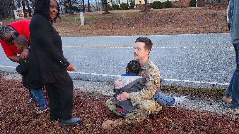 U.S. Army Capt. Jeremy Willman comforts a child after a vehicle accident in front of the armory in Wadesboro, N.C., February 26, 2026. Soldiers from Alpha Co, 236th Brigade Engineer Battalion, responded to the vehicle accident while waiting for emergency services to arrive on the scene. (courtesy photo by U.S. Army Sgt. 1st Class Austin Adkins)