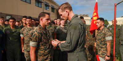 U.S. Marine Corps Lt. Col. Paul Cordes, commanding officer of Marine Aerial Refueler Transport Squadron (VMGR) 153, Marine Aircraft Group 24, 1st Marine Aircraft Wing, awards Sgt. Garrett Sloan, a loadmaster with VMGR-153, the Navy and Marine Corps Commendation Medal at Marine Corps Air Station Kaneohe Bay, Hawaii, March 5, 2026. Sloan received the award after rescuing two local children who were swept out to sea by a rip current while swimming at Makapu’u beach. (U.S. Marine Corps photo by Lance Cpl. Chandler Evans)