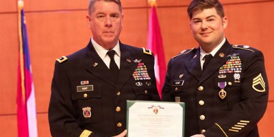 Maj. Gen. Todd Hunt (Left), NC Adjutant General present U.S. Army Staff Sgt. David Hunt (right), 130th Military History Detachment, the Purple Heart at Joint Force Headquarters in Raleigh, NC on March 6, 2026. The Purple Heart is the oldest military award still presented to American service members of the armed forces who have been wounded or killed in the line of duty. (U.S. Army National Guard Photo by Sgt. Brittany)