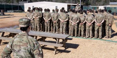 Students at the Army's Survival, Evasion, Resistance, and Escape course at Fort Rucker complete their culminating exercise, and gather to salute the American flag as they begin the repatriation process during the recent large-scale reintegration exercise in conjunction with US Army South, the Joint Personnel Recovery Agency, the U.S. Air Force, the U.S. Navy, and U.S. Army Special Operations Command from March 14-18, 2026. (Contributed Photo)